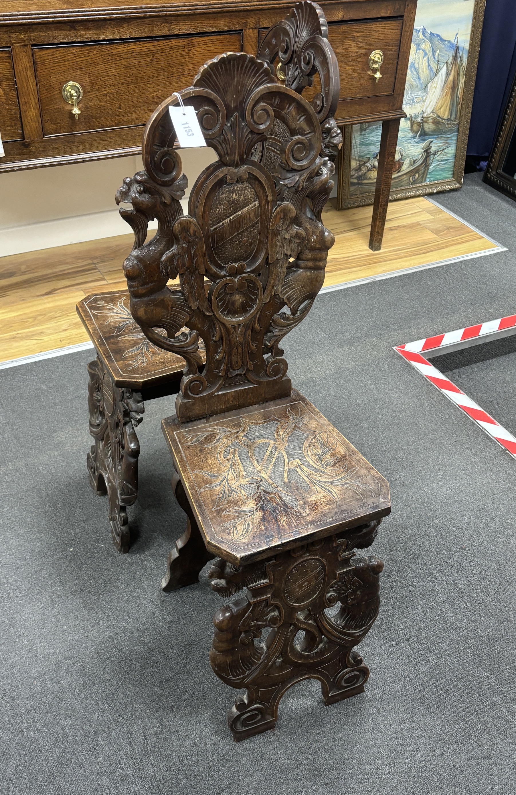 A pair of 18th century style carved walnut hall chairs, width 36cm, depth 27cm, height 106cm